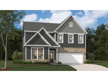 New two-story home with a brick and siding exterior and a two-car garage at 218 Macon Lake Drive # 43, Apex, NC 27523
