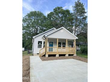 Charming single-story home with a welcoming front porch and a newly paved driveway at 2301 Pinecroft Dr, Burlington, NC 27217