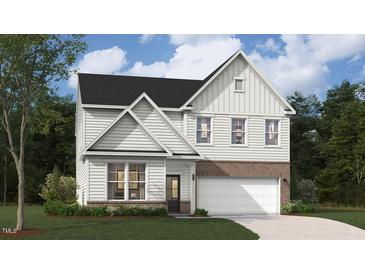 Charming two-story home featuring a brick foundation and a two-car garage at 246 Macon Lake Drive # 36, Apex, NC 27523