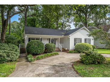 Charming single story home with a concrete driveway and a well maintained, manicured front yard and mature trees at 2629 Hiking Trl, Raleigh, NC 27615