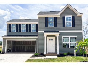 Two-story home with gray siding, black shutters, and an attached two-car garage at 306 Rosewood Dr, Sanford, NC 27330