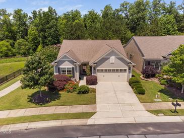 Charming single-story home featuring a well-manicured lawn and a two-car attached garage at 323 Rosedale Creek Dr, Durham, NC 27703
