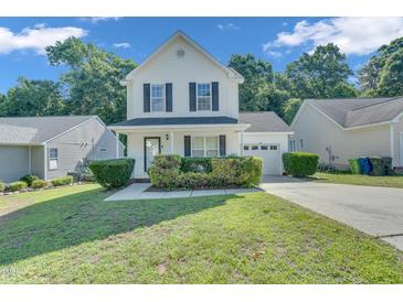 Charming two-story home with black shutters and a well-manicured lawn at 5617 Tealbrook Dr, Raleigh, NC 27610