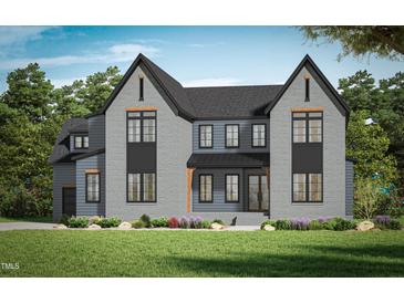 Charming two-story home with modern gray brick, a landscaped yard, and dark trimmed windows at 5841 Carriage Gate Dr, Raleigh, NC 27603