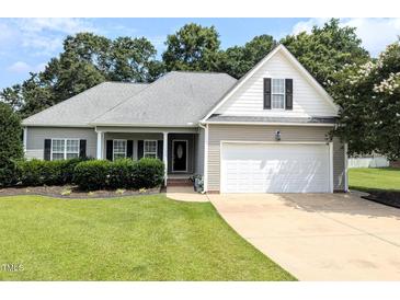 Charming single-story home featuring a two-car garage and well-maintained landscaping in a suburban setting at 70 Dexterfield Dr, Fuquay Varina, NC 27526
