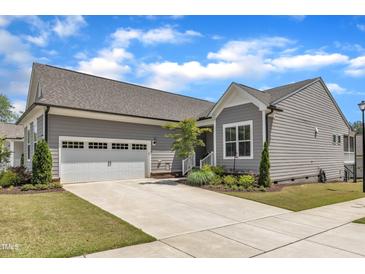 Charming single-Gathering home with a two-car garage and a well-manicured lawn in a residential neighborhood at 704 Haven Peak Ln, Wake Forest, NC 27587
