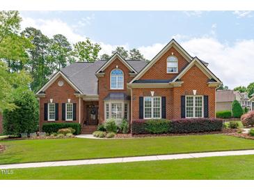 Charming brick two-story home with manicured lawn and mature landscaping, featuring black shutters and a bay window at 204 Franconia Way, Apex, NC 27502