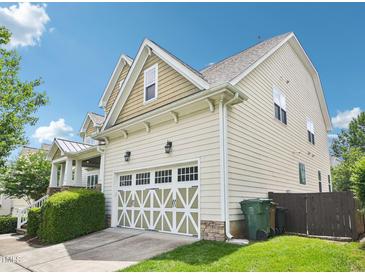 Two-story home featuring a well-manicured lawn, a two-car garage, and vinyl siding with a charming gable roof at 214 Ashdown Forest Ln, Cary, NC 27519