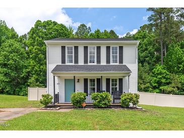 Charming two-story home with a manicured front yard and inviting front porch at 411 Buxton St, Durham, NC 27713