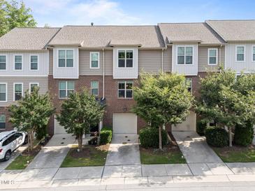 A row of two-story townhomes with attached garages and well-maintained landscaping at 4124 Sykes St, Cary, NC 27519