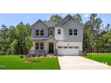 Beautiful two-story home featuring gray and white siding, a covered porch, and a spacious two-car garage at 4824 Bristol Meadow Dr, Raleigh, NC 27603