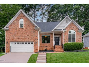 Charming brick home with a well-manicured lawn and inviting entrance at 6313 Belle Crest Dr, Raleigh, NC 27612
