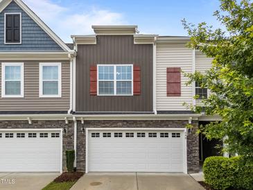 Charming townhouse featuring stone accents, a two-car garage, and complementary neutral siding at 640 Barneswyck Dr, Fuquay Varina, NC 27526