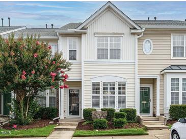 Charming townhome featuring a well-maintained facade, lush landscaping, and inviting curb appeal at 7646 Winners Edge St, Raleigh, NC 27617