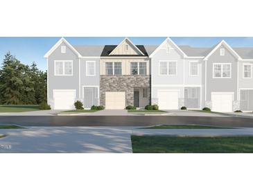 New townhome exterior showing the stone and siding details on the front facade at 1131 Weavers Trace Dr, Zebulon, NC 27597