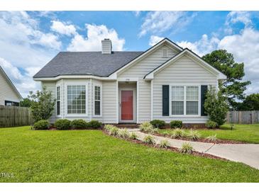 Charming single-story home with a well-manicured lawn and inviting red front door at 1516 Greys Mill Rd, Rocky Mount, NC 27804