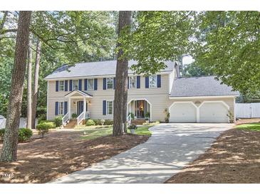 Charming two-story home featuring blue shutters, a two-car garage, and a well-manicured lawn at 1913 Fawndale Dr, Raleigh, NC 27612