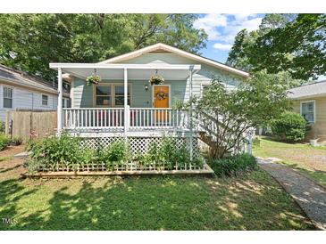 Charming home featuring a covered front porch and beautiful landscaping at 2322 Stroller Ave, Durham, NC 27705