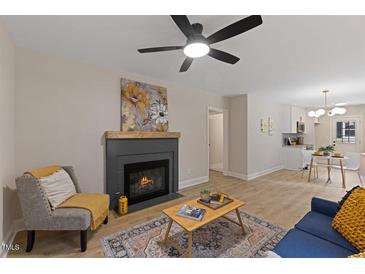 Comfortable living room featuring a fireplace, ceiling fan, and modern furnishings at 308 Greenwood Dr, Durham, NC 27704
