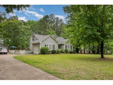 Charming single-story home with a well-manicured lawn and beautiful landscaping at 313 Teresa Dr, Rolesville, NC 27571