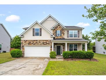 Charming two-story home featuring stone accents, a covered porch, and a well-manicured lawn at 326 Hope Valley Rd, Knightdale, NC 27545