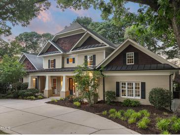 Stately two-story home featuring manicured landscaping, elegant columns, and a welcoming front porch at 3324 Thomas Rd, Raleigh, NC 27607