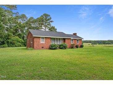 Charming single-story brick home with a well-maintained lawn and mature trees at 445 Lee County Line Rd, Broadway, NC 27505