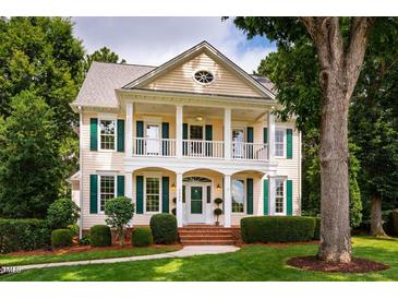 Stunning two-story home with a charming front porch and meticulously landscaped front yard at 5205 Coffeetree Dr, Raleigh, NC 27613