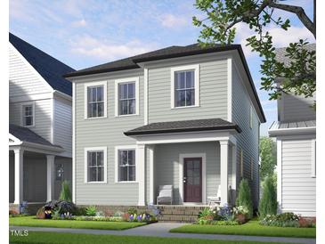 Charming two-story home with a covered porch and beautifully landscaped front yard at 524 Folk Song Way, Wendell, NC 27591