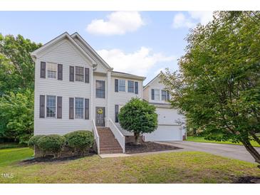 Charming two-story home featuring white siding, black shutters, and a well-manicured lawn at 5308 Bentgrass Dr, Raleigh, NC 27610