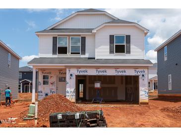 New construction of a two-story home featuring an unfinished front yard and an attached two-car garage at 644 Red River Dr, Garner, NC 27529