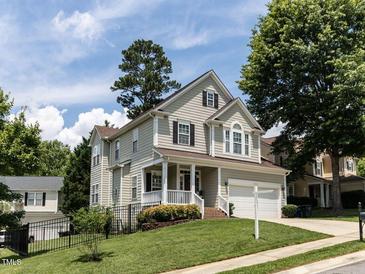Charming two-story home with a well-manicured lawn and a welcoming front porch at 8001 Strawberry Meadows St, Raleigh, NC 27613