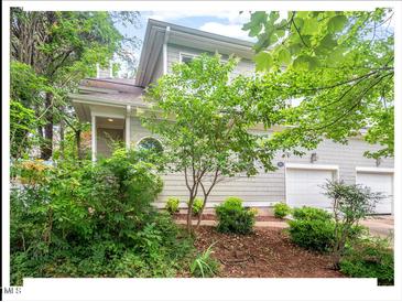 Two-story home with gray siding, lush landscaping, and a two-car garage at 805 N Columbia St, Chapel Hill, NC 27516