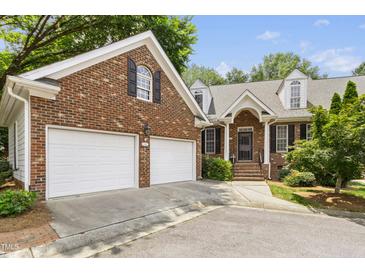 Charming brick home with a two-car garage and well-manicured landscaping at 1003 Blackberry Ln, Durham, NC 27712