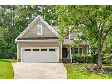 Charming home featuring a two-car garage, well-manicured lawn, and inviting front porch at 113 Chestone Ct, Cary, NC 27513