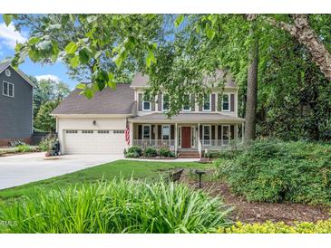 Charming two-story home featuring a welcoming front porch and well-manicured landscaping at 203 W Hill Dr, Cary, NC 27519