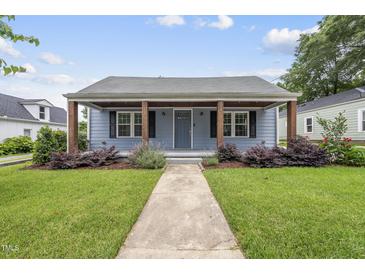 Charming blue home featuring a cozy front porch with lovely landscaping and inviting curb appeal at 208 Maywood Ave, Raleigh, NC 27603