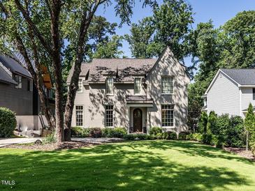 Charming home with a manicured lawn, mature trees, and a classic brick facade at 2125 Pine Dr, Raleigh, NC 27608