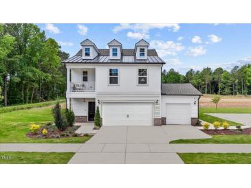 Beautiful two-story home boasts white siding, dormer windows, and a manicured lawn at 223 Faith Avenue, Sanford, NC 27330