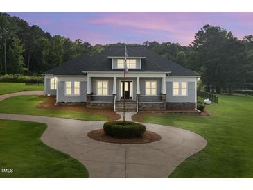 Charming single-Gathering home with a circular driveway and manicured lawn at 2493 Nc-242, Benson, NC 27504
