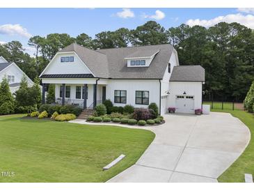 Charming, modern farmhouse-style home featuring a well-manicured lawn and a spacious driveway at 3829 Sleepy Brook Ln, Apex, NC 27539