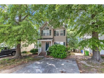 Charming two-story home with a well-maintained front yard and a classic facade, showcasing its inviting curb appeal at 4825 Windbreak Ln, Raleigh, NC 27616