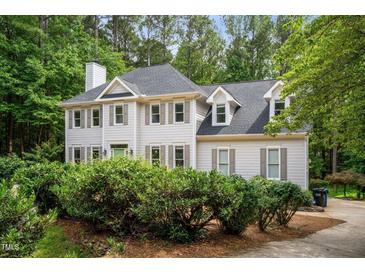 Charming two-story traditional home featuring neutral siding, dormers and professional landscaping at 5809 N Hawthorne Way, Raleigh, NC 27603