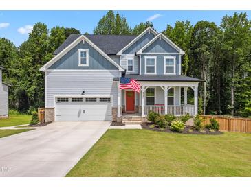 Charming two-story home with a welcoming front porch and attached two car garage at 70 Noble Heart Pl, Fuquay Varina, NC 27526