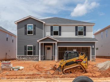 New two-story home showcasing gray and white siding, black shutters, and an attached two-car garage at 752 Deschutes Dr, Garner, NC 27529