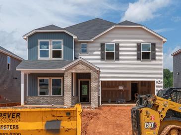 Two-story home featuring blue and white siding, a brick entryway, and an attached garage at 756 Deschutes Dr, Garner, NC 27529