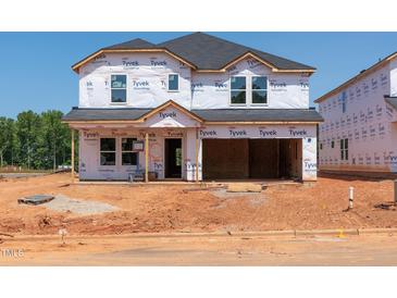 Exterior shot of an incomplete two-story home with Tyvek wrap, ready for customization at 760 Deschutes Dr, Garner, NC 27529