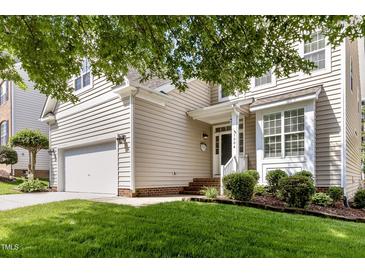 Charming home with a well-manicured lawn, two-car garage, and inviting front porch at 1304 Trailing Rose Ct, Wake Forest, NC 27587