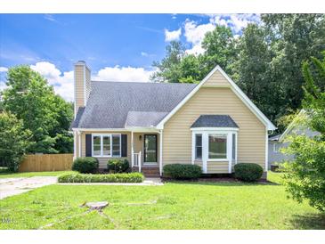 Charming home with a manicured lawn and mature landscaping creating a welcoming curb appeal at 1309 Sweet Charm Ln, Knightdale, NC 27545