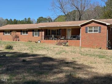 Charming brick home with a covered front porch and spacious front yard at 1802 Holiday Rd, Sanford, NC 27330
